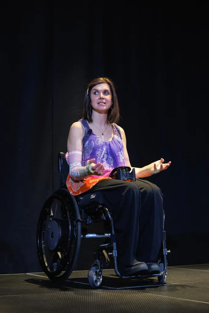 Katy Deacon on stage delivering a keynote speech